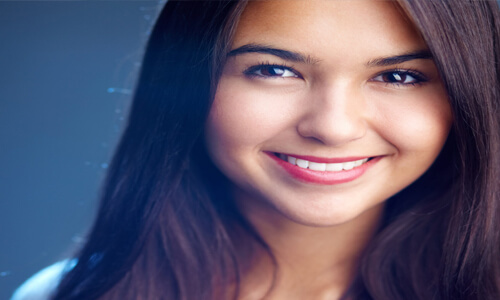 Picture of a young woman with dark hair smiling