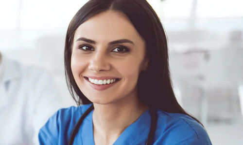 Picture of a young nurse smiling back at the camera