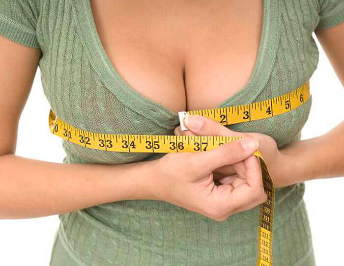 Picture of a happy woman with her breast lift with reduction and implants.