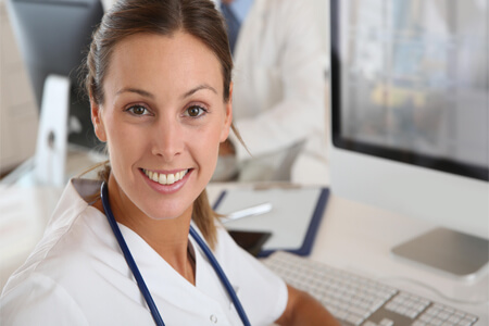 Picture of a brunette nurse smiling back at the camera